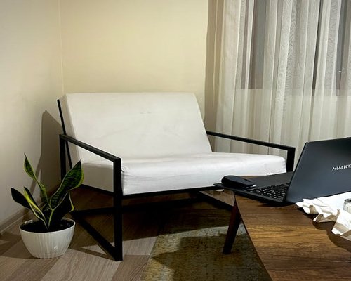 Cozy home office with soft green lighting and comfortable furniture