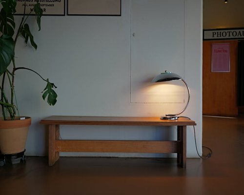 Minimalist stylish floor lamp providing warm light in a modern workspace